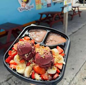 zwei Tabletts mit schokoladenüberzogenen Erdbeeren und Früchten in einem Tablett in der Unterkunft Islabella Guest House in Isabela