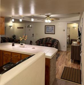 a kitchen with a counter and a living room at Cozy Cottage House A with Carport in Twin Falls