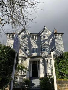 a white house with two street signs in front of it at Cozy Two Bedroom Apartment in London