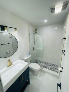 a bathroom with a sink and a toilet and a shower at Cozy Comfy House in Pembroke Pines