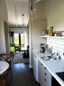 a kitchen with a sink and a counter top at Luxury cottage with stunning vineyard views in Renwick