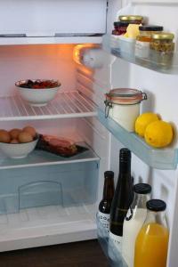 an open refrigerator with food and drinks in it at Luxury cottage with stunning vineyard views in Renwick