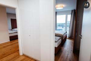 a room with two beds and a door with a window at Albelli Luxury Skyview in Košice