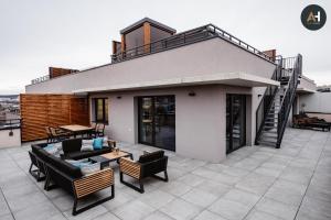 a house with a roof with a patio at Albelli Luxury Skyview in Košice