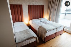 a hotel room with two beds and a window at Albelli Luxury Skyview in Košice