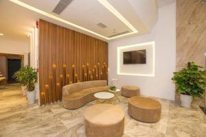 a lobby with a couch and a table and stools at Hai Trieu Hotel in Da Nang