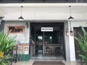 an entrance to a restaurant with tables and chairs at WF Motel in Kulim