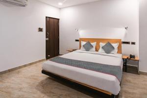 um quarto com uma cama grande num quarto em Townhouse De Alphabet Karmanghat em Hyderabad