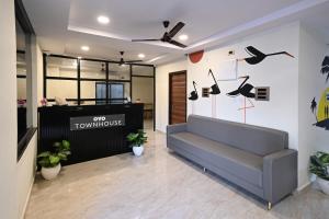 an office lobby with a couch and shoes on the wall at Townhouse De Alphabet Karmanghat in Hyderabad