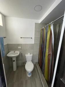 a bathroom with a toilet and a sink at Casa Halley #6 con vista al mar in Playas