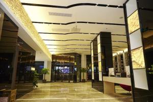 a lobby of a building with a hallway with mirrors at Lavande Hotel Sanya Sanya Bay Jixiang Street in Sanya