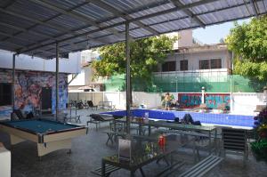 a pool table and ping pong tables in a patio at Top One Backpacker Hostel in Vientiane