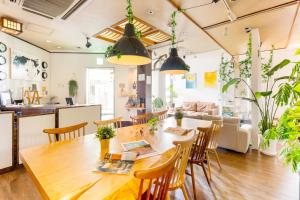 a dining room and living room with a table and chairs at Nara Guesthouse 3F in Nara