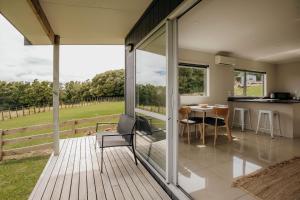 een open terras met een tafel en stoelen op een huis bij Dorset Retreat in Hillsborough