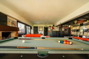 a pool table with cue balls on top of it at Hostel 32 in Punta del Este