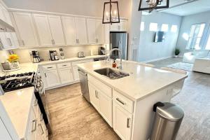 a kitchen with white cabinets and a sink at Townhouse in Houston in Houston