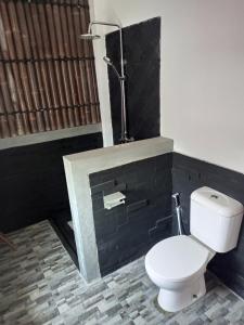 a bathroom with a toilet and a fireplace at ZEN MOON Hostel in Yogyakarta