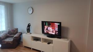 a living room with a television on a white entertainment center at Apartaments - Liepu iela in Liepāja
