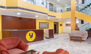 a lobby with couches and chairs in a building at Treebo Trend Y Hotels Elite - Jagamara in Bhubaneshwar