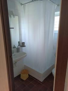 een badkamer met een douche, een wastafel en een toilet bij Apartamento estilo marinero en Calella Palafrugell in Palafrugell