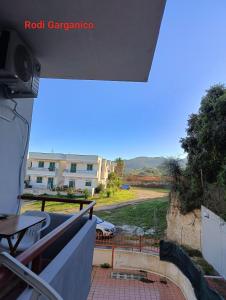 a balcony with a view of a building and a car at Marechiaro in Foce Varano