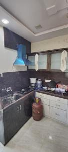 a kitchen with a stove and a sink in it at SCK Home Stay in Hyderabad