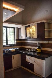 a kitchen with a black counter top and a sink at Home with garden in a serene locality in Wayanad