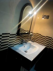 a bathroom with a sink and a mirror at Victoria Nature Resort in Digana