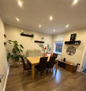 a dining room with a table and chairs at Adam’s Place, Watford WD17 2PY (near Harry Potter) in Watford