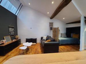 a living room with a couch and a bed at Plan B in Saint-Jean-Pied-de-Port