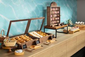 a display of different types of bread and pastries on a counter at the b osaka-shinsekai in Osaka