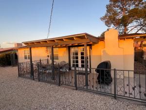 a house with a fence in front of it at The Hummingbird Sunset Home, West Side in El Paso