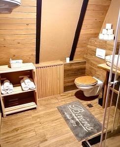 a bathroom with a toilet in a wooden room at Hanina Village Resort - l i ll in Čajniče