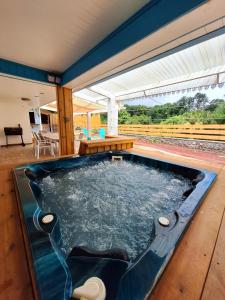 a hot tub in the middle of a house at PEACE & LODGE II in Saint-Joseph