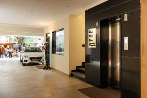 a hallway with a car parked in a building at V V Grand in Chennai