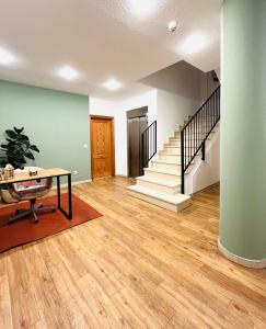 an empty living room with a table and stairs at Aptos La Costera in Benidorm