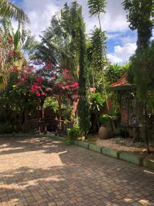 a garden with pink flowers and a house at Hidden oasis in Mandeville