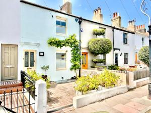 a white house with plants in front of it at Stylish, Central, North Laine, Newly Decorated in Brighton & Hove