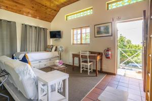 a bedroom with a bed and a desk at Lanherne Guest House Bed & Breakfast in Grahamstown