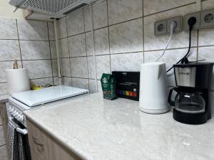 a kitchen counter with a coffee maker and a coffeemaker at AradVest Studio in Arad