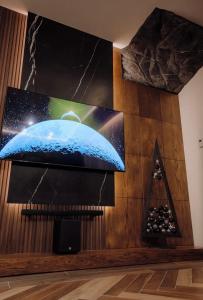 a flat screen tv on a wall in a room at Moonlight in Tsaghkadzor