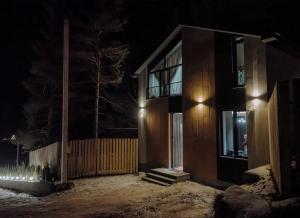 a house at night with snow in front of it at Moonlight in Tsaghkadzor