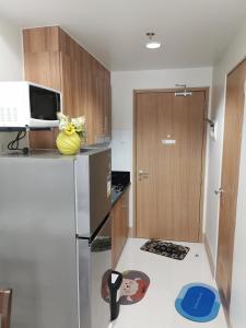 a kitchen with a refrigerator and a microwave at Shore 3 tower 2 mall of Asia in Manila