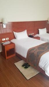 Säng eller sängar i ett rum på Armah International Hotel