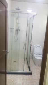 a bathroom with a shower and a toilet at Armah International Hotel in Āksum