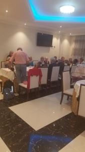 eine Gruppe von Menschen, die an einem Tisch in einem Restaurant sitzen in der Unterkunft Armah International Hotel in Aksum