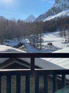 a view of a snow covered mountain from a balcony at JARDIN DES ANGLAIS in Rhêmes-Notre-Dame