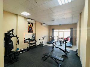 a gym with several treadmills and machines in a room at Royal Land Deluxe Suites رويال لاند للأجنحة الفاخرة in Duqm