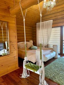 a bedroom with two beds and a swing at VIP ШАЛЕ ТИША in Shirokaya Greblya +65 photos