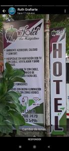 a sign for a hotel on a pole at Hotel los Mangostinos calle 7 número 5-26 frente al expreso Bolivariano in Mariquita